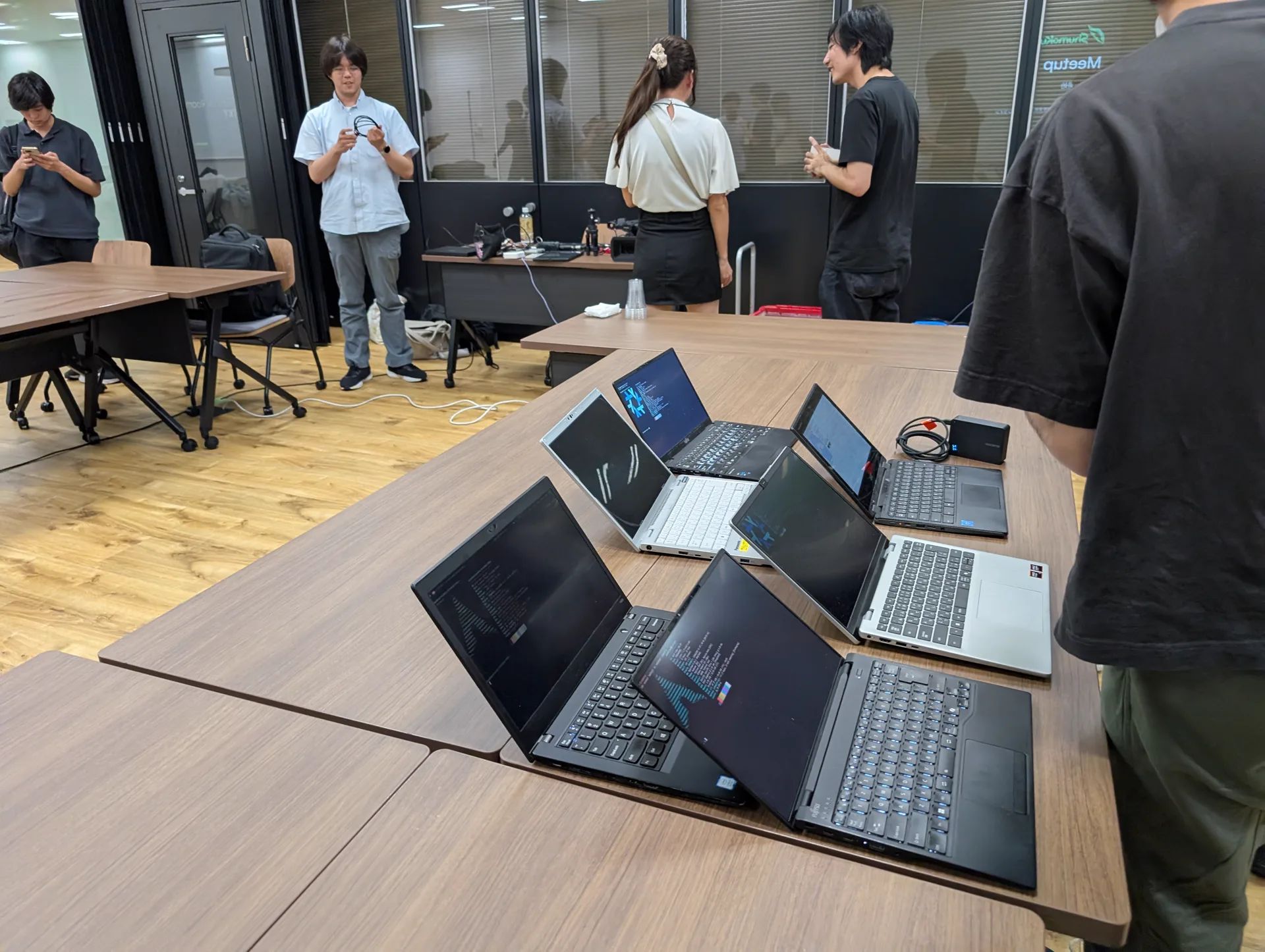 Attendees’ laptops lined up on the table.